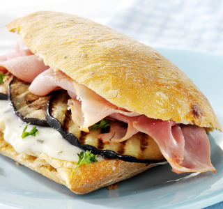 Ciabatta roll with ham, roasted aubergine and fresh herbs