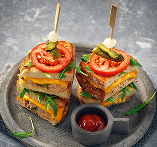 Pan toastie with cheddar, sambal, tuna, capers, gherkin and tomato