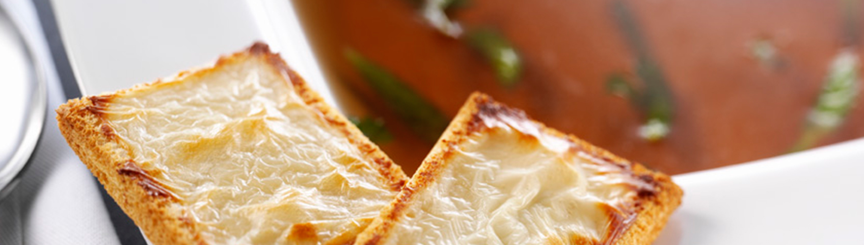 Beef consommé with haricot verts and toast with ERU Spreadable Goat Cheese