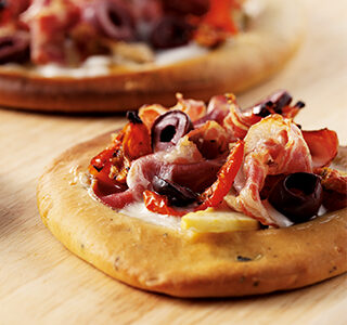 Pizza with ERU Spreadable Goat Cheese, Coppa di Parma and olives